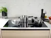 A kitchen counter with a stovetop and cookware. Produktbild-Vorschau