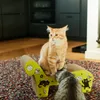 Two cats interacting with a cardboard scratching post in a modern kitchen setting. Podgląd zdjęcia produktu