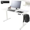 A white electric standing desk with a computer monitor, keyboard, mouse, and a backpack hanging from the side.