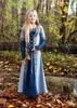 A young girl in a medieval-style dress stands in a forest during autumn. Produktbild-Vorschau