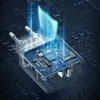A close-up, angled view of a transparent power adapter with a blue circuit board inside, set against a dark, textured background that resembles a circuit board. Blue light emanates from the adapter, suggesting power or protection. Anteprima dell’immagine prodotto
