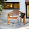 A wooden garden bench with cushions and a throw blanket on a patio. Podgląd zdjęcia produktu