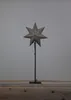 A star-shaped ornament on a stand against a plain background. Podgląd zdjęcia produktu