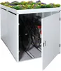 A white bicycle garage with a green roof covered in flowers, containing two bicycles. One of the garage doors is open. Náhled obrázku produktu