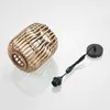 A pendant lamp shade made of rattan and a black cord with a socket and ceiling mount are shown on a white background. Produktbild-Vorschau