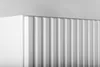 A close-up shot of a white cabinet with vertical fluting. Podgląd zdjęcia produktu