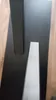 A close-up view of a black table base with two legs, one black and one gray, on a wooden floor. Produktbild-Vorschau