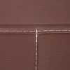 A close-up view of brown leather material with white stitching. Podgląd zdjęcia produktu