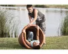 Two boys playing with a large planter pot near a lake. Produktbild-Vorschau