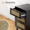 A black nightstand with rattan drawer fronts, with one drawer pulled out to show the interior and drawer slides. A close-up of the rattan weave is shown in the bottom left corner. Text overlays describe the material and design. Voir les images du produit