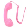 A pink retro telephone handset with a coiled cord and a 3.5mm jack connector, isolated on a white background. Náhľad obrázku produktu