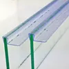 Close-up of two clear plastic shower door seals with water droplets on them, attached to glass panels. Produktbild-Vorschau