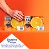 A hand with red nail polish is reaching towards two Epson ink multipacks, which are placed in front of sliced oranges. Náhled obrázku produktu