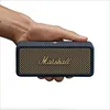 A hand holding a portable Bluetooth speaker. Produktbild-Vorschau