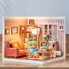 A miniature dollhouse room with a character sitting on a chair. Anteprima dell’immagine prodotto