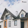 A modern house with a prominent roofline and windows, under a cloudy sky. Anteprima dell’immagine prodotto