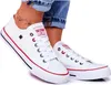 A person wearing white Big Star sneakers and blue jeans. Produktbild-Vorschau