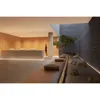 A modern reception area with a minimalist design, featuring a reception desk, wooden paneling, and a Japanese-inspired zen garden with a bonsai tree and rocks. Náhled obrázku produktu