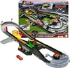 A Disney Pixar Cars Piston Cup Action-Rennstrecke Spielset with Lightning McQueen toy car is shown, with the product packaging in the background. Produktbild-Vorschau