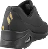 A rear view of a black Skechers sports shoe with gold accents. Voir les images du produit