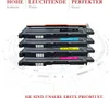 A stack of four toner cartridges with labels indicating their colors and model numbers. Produktbild-Vorschau