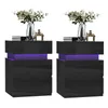 Two black nightstands with purple LED lighting, each topped with a vase of flowers and books. Produktbild-Vorschau