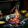 Strawberries being flambéed in a pan with flames, with lemons and a sauce in the background. Náhľad obrázku produktu