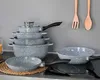 A set of cookware, including pots and pans, is displayed on a kitchen counter. Náhľad obrázku produktu