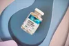 A bottle of OstroVit Marine Collagen supplements is placed on a wavy, abstract background. Náhľad obrázku produktu