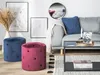 A living room scene with a sofa, coffee table, and two poufs. Náhled obrázku produktu