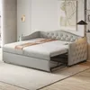 A light gray sofa bed is shown in a room with a rug and artwork on the wall. Produktbild-Vorschau