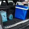 A blue cooler box being placed into the trunk of a car, alongside other bags. Náhled obrázku produktu