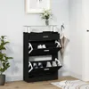 A black shoe cabinet with multiple compartments and a glass top, placed in a room with a plant and a framed picture on the wall. Anteprima dell’immagine prodotto