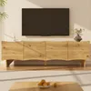 A modern living room scene with a TV mounted on the wall above a wooden TV stand. Produktbild-Vorschau