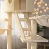A close-up view of a beige cat tree with multiple levels, scratching posts, and a hammock. Náhled obrázku produktu