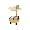 A small, two-tiered side table with wheels, displaying a cup, a calendar, and some books. Produktbild-Vorschau