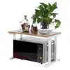 A microwave oven stand with items on top. Voir les images du produit