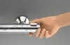 A hand is shown adjusting a chrome shower thermostat. Anteprima dell’immagine prodotto
