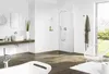 A modern bathroom with a bathtub, sink, shower, and a chair. Voir les images du produit