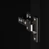 A close-up shot of a black cabinet hinge on a black background. Produktbild-Vorschau