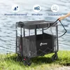 A black foldable wagon with a clear rain cover is shown outdoors near water and grass. Produktbild-Vorschau
