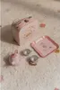 A children's tea set with a suitcase, cups, and a tray, laid out on a fluffy rug. Anteprima dell’immagine prodotto