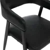 A close-up view of a black leather chair. Náhled obrázku produktu