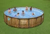 People enjoying a round above-ground swimming pool in a grassy backyard. Produktbild-Vorschau