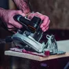 A person is using a circular saw to cut a piece of wood. Náhled obrázku produktu