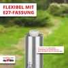A close-up of a silver outdoor lamp with text overlays, set against a blurred green garden background. Produktbild-Vorschau