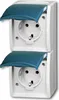 A close-up studio shot of two stacked white electrical outlets with blue protective covers. Produktbild-Vorschau
