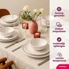 A table setting with plates, bowls, glasses, and flowers, with marketing text overlays. Náhled obrázku produktu