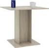 A square wooden dining table with a pedestal base, shown against a white background. Two white mugs and a blue object are placed on the tabletop. Produktbild-Vorschau