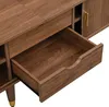 A close-up view of an open drawer in a wooden TV cabinet. Anteprima dell’immagine prodotto